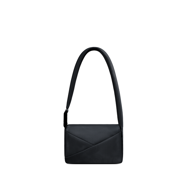 Lux & Nyx Origami Flap Bag in Black, crossbody bag presented in its alternate wear as a mini shoulder bag.