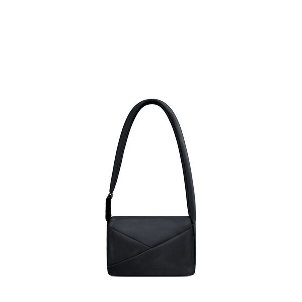 Lux & Nyx Origami Flap Bag in Black, crossbody bag presented in its alternate wear as a mini shoulder bag.