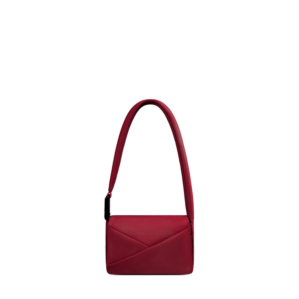 Lux & Nyx Origami Flap Bag in Crimson, crossbody bag presented in its alternate wear as a mini shoulder bag.