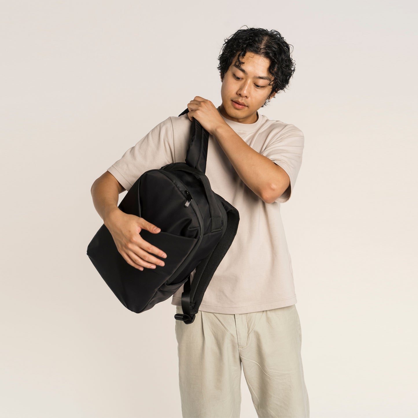 Person holding a black bag 