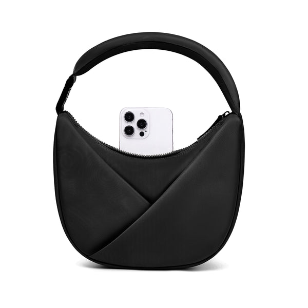Black handbag with a phone inside on a white background