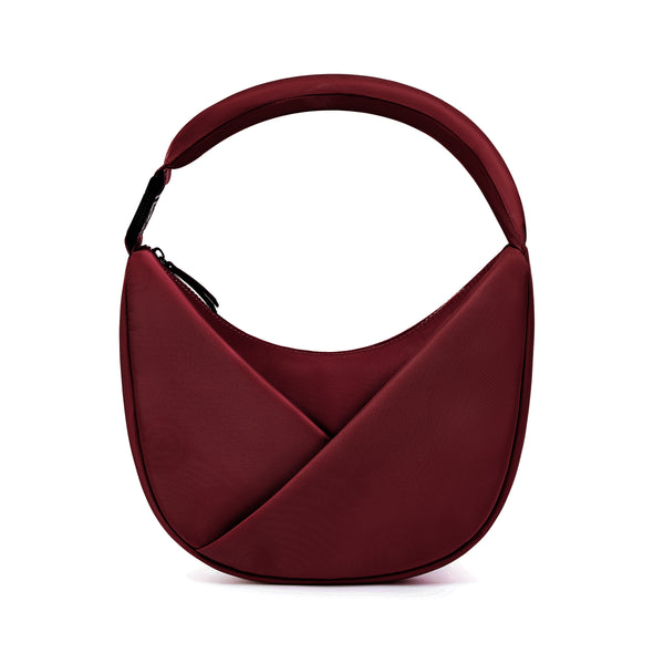 Burgundy handbag with a criss-cross design on a white background