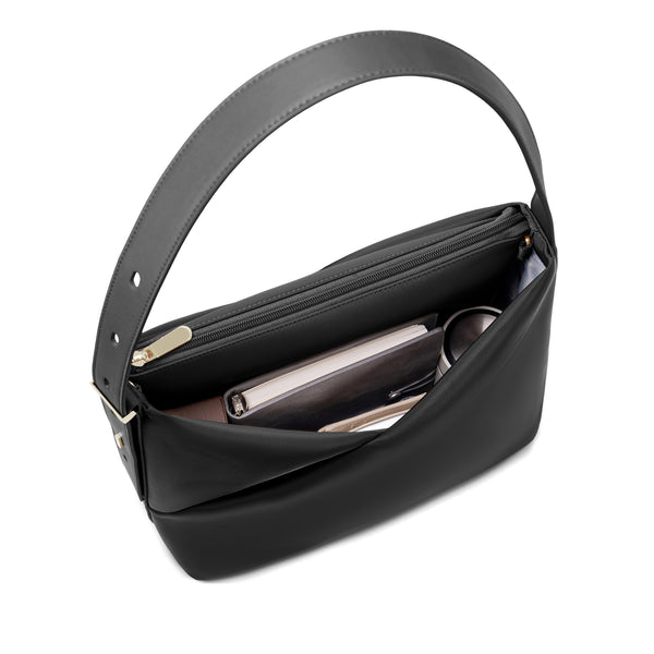 Interior view of the black Origami Hobo Bag organized with a phone and essentials, showing gold-tone base feet.
