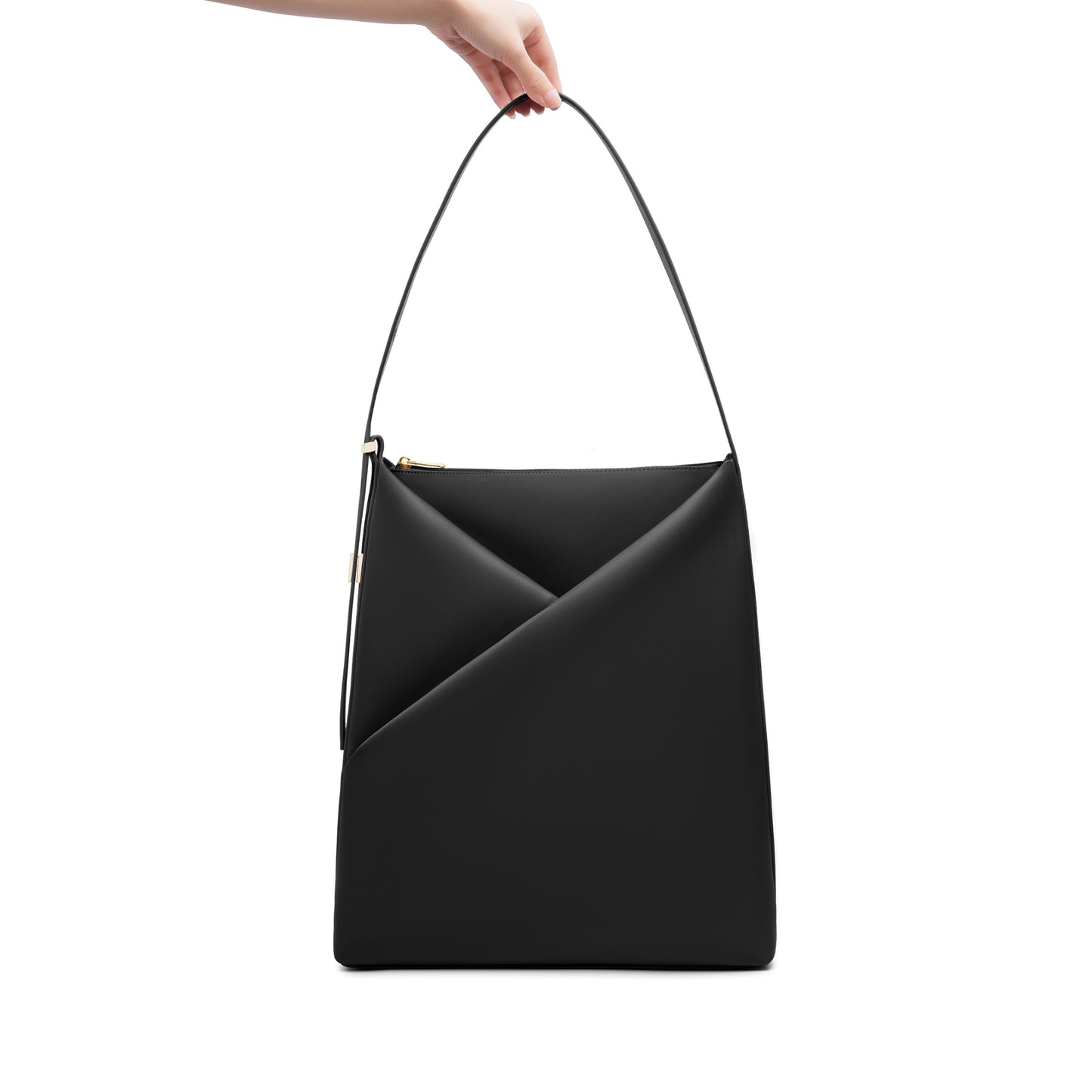 Black Origami Hobo Bag held by its handle, emphasizing the structured origami silhouette.
