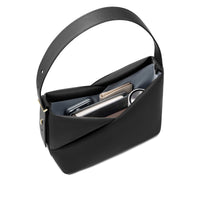 Top view of the black Origami Hobo Bag held open, showing the curved handle and interior essentials.
