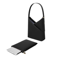 Black Origami Hobo Bag shown with its detachable padded laptop sleeve pouch beside it.
