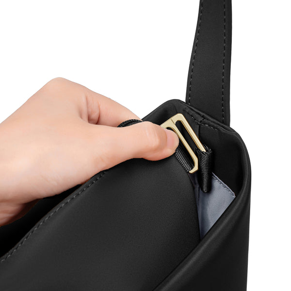 Close-up of a hand opening the black Origami Hobo Bag's gold-tone clasp hardware.
