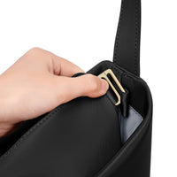 Close-up of a hand opening the black Origami Hobo Bag's gold-tone clasp hardware.
