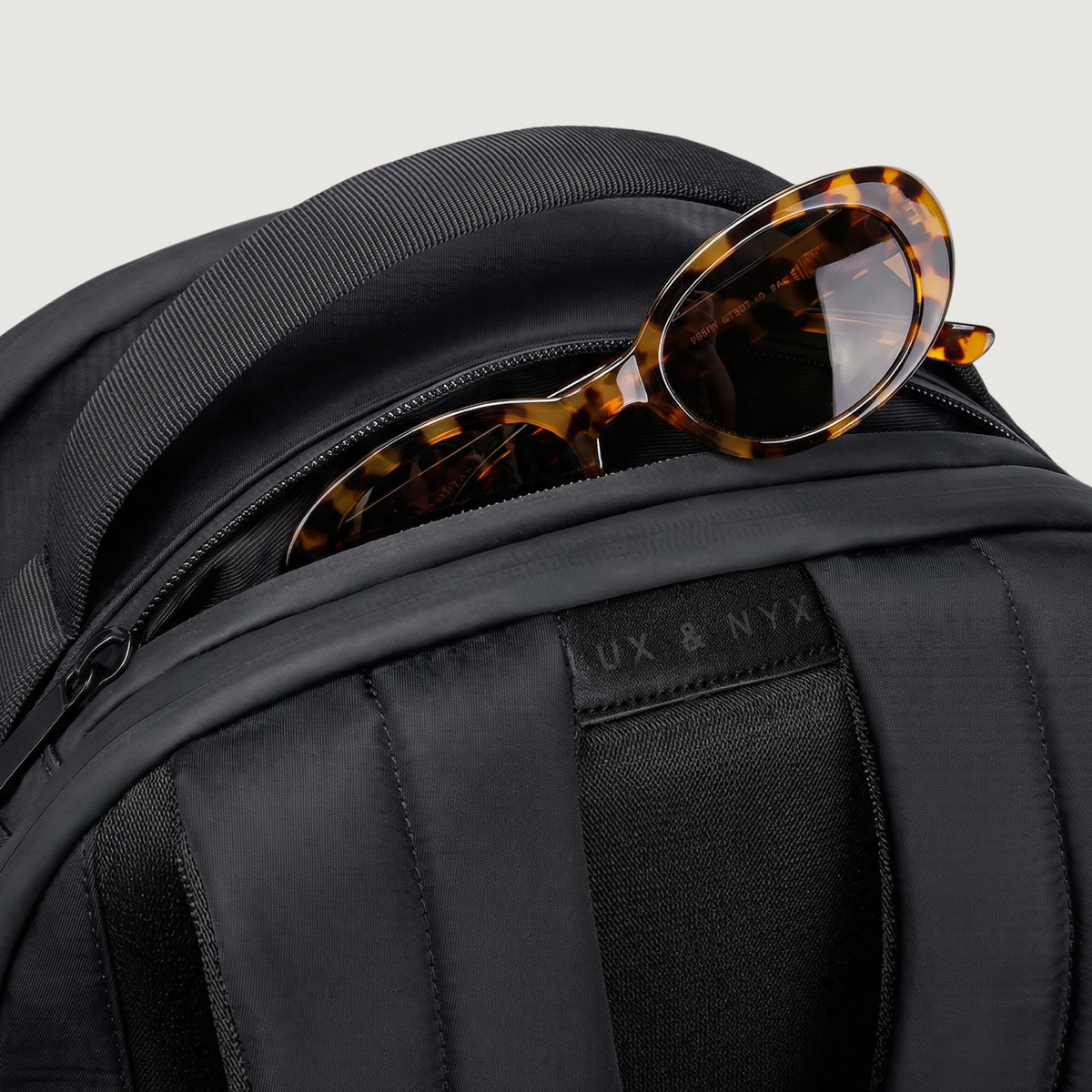 Lux & Nyx Origami Backpack - 16" Laptop Backpack With Trolley Strap - Black - Top zipper pocket with sunglasses
