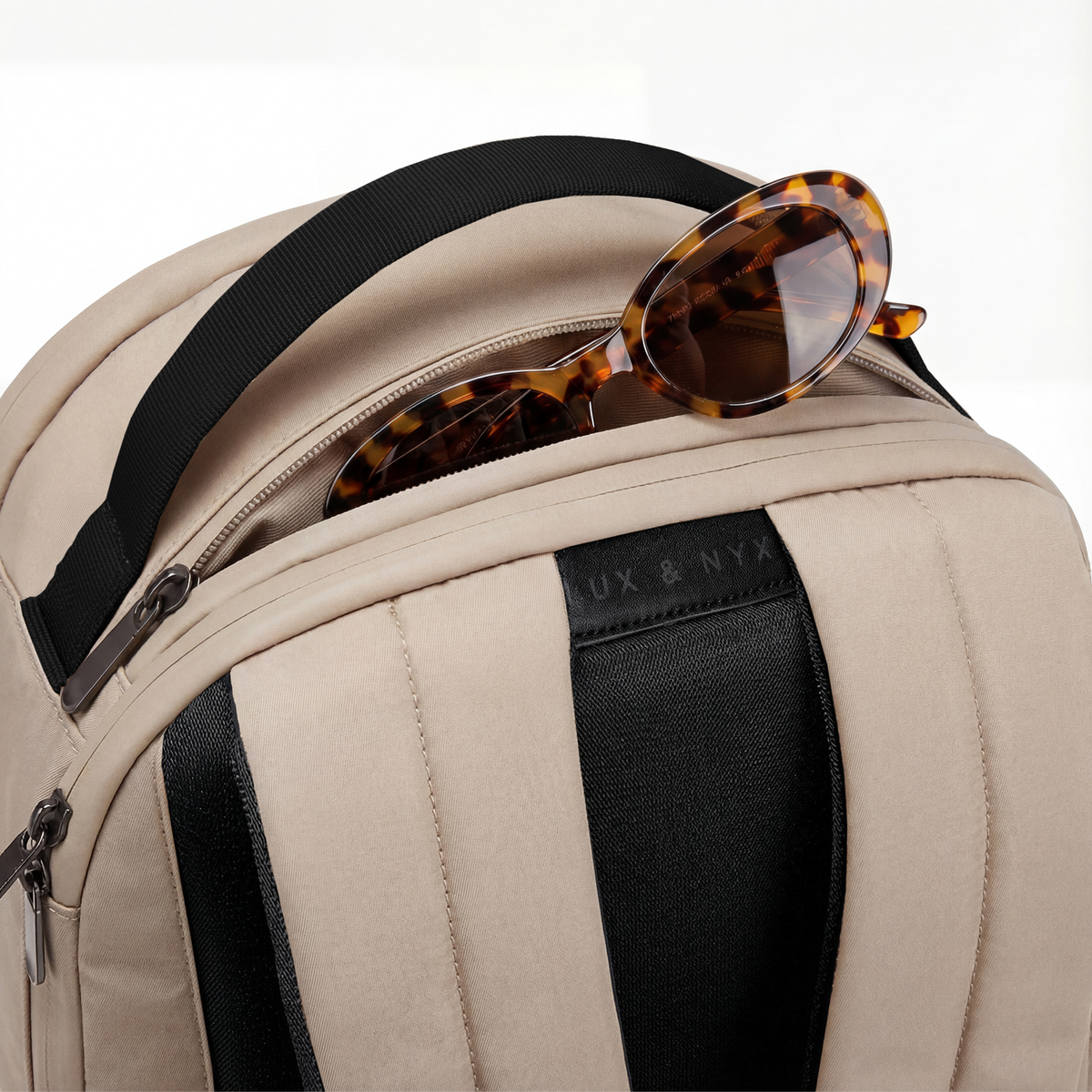 Lux & Nyx Origami Backpack - 16" Laptop Backpack With Trolley Strap - 
Champagne Taupe Close-up of top zipper pocket.