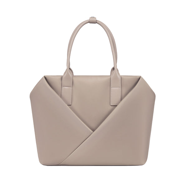 Lux & Nyx champagne taupe handbag with a geometric V-shaped envelope front panel and dual top handles.