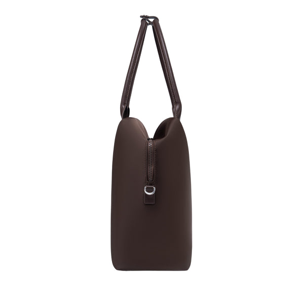 Side profile of an espresso origami handbag highlighting its slim depth, arched top handles, and clasp closure.
