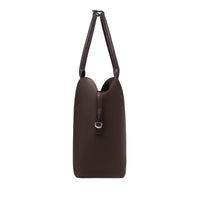 Side profile of an espresso origami handbag highlighting its slim depth, arched top handles, and clasp closure.
