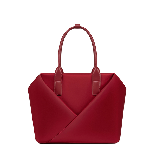 Lux & Nyx Crimson handbag with a geometric V-shaped envelope front panel and dual top handles.