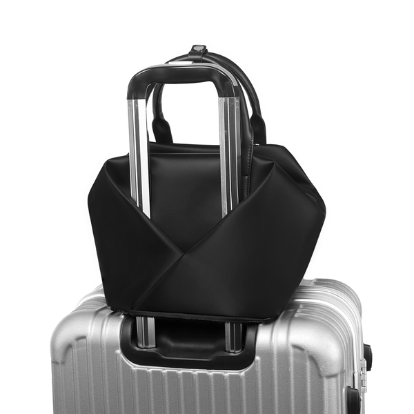 Front  view of a  Mid Origami handbag, Available in black with gold hardware color with suitcase