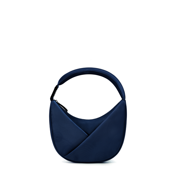 Lux & Nyx Origami Crescent bag in Midnight Blue. Moon shaped bag that features an origami front pocket in its alternate use as a shoulder bag.