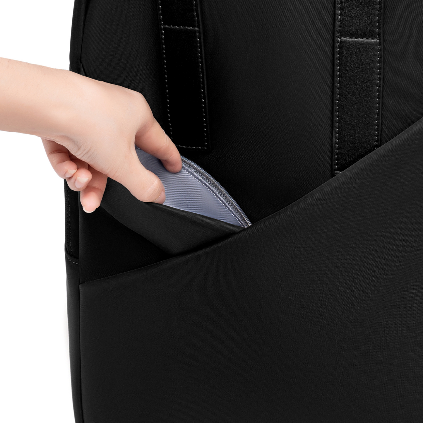 Hand accessing hidden side pocket on Origami Slim Black Backpack, showing concealed zip compartment