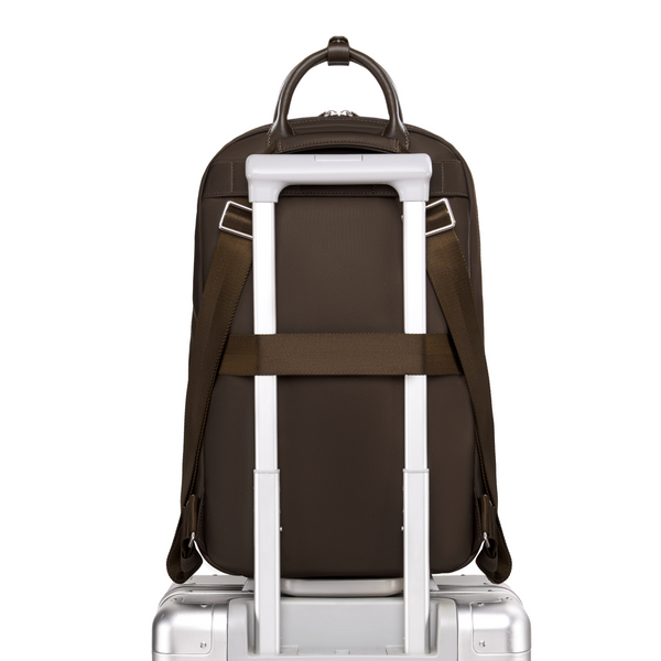 Origami Slim Espresso Backpack secured on rolling luggage handle, showing luggage sleeve passthrough