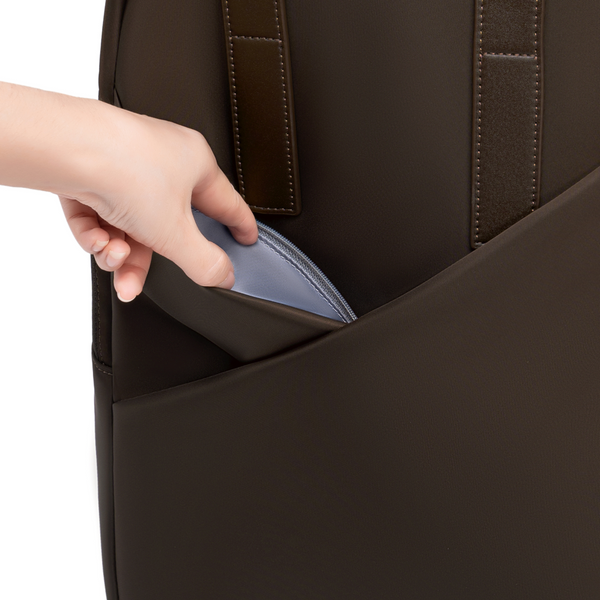 Hand accessing hidden side pocket on Origami Slim Espresso Backpack, showing concealed zip compartment