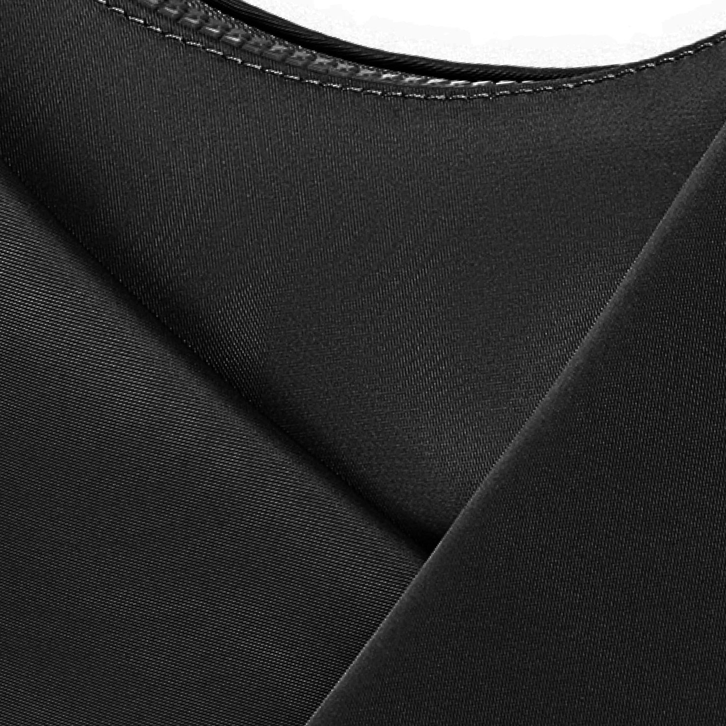 Close-up of black fabric with a subtle texture on a white background