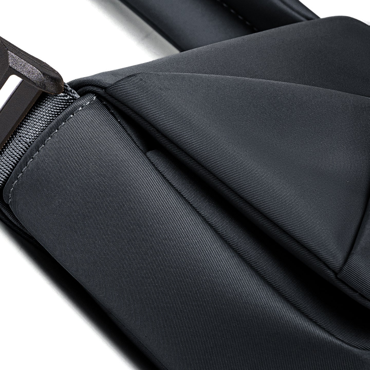 Close-up of a black bag with a zipper on a white background