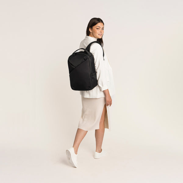 Lux & Nyx Origami Backpack - 16" Laptop Backpack With Trolley Strap - Black - Professional Woman Wearing The Origami Backpack in Black