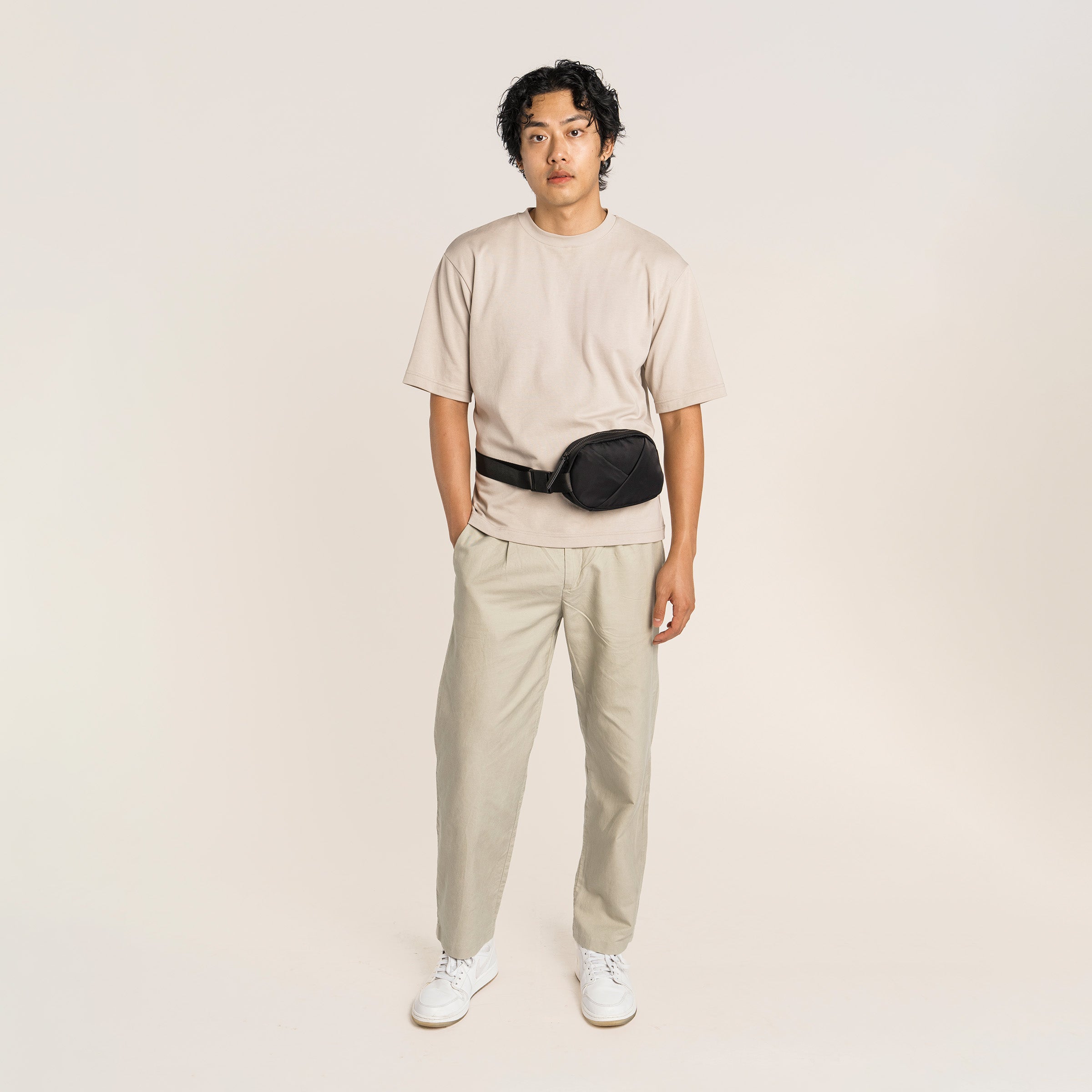 Lux & Nyx Origami Belt Bag and Sling Bag - Black - Male Model Wearing The Belt Bag In Belt Bag Mode