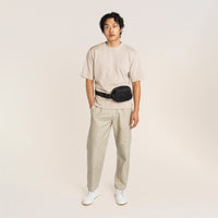 Lux & Nyx Origami Belt Bag and Sling Bag - Black - Male Model Wearing The Belt Bag In Belt Bag Mode