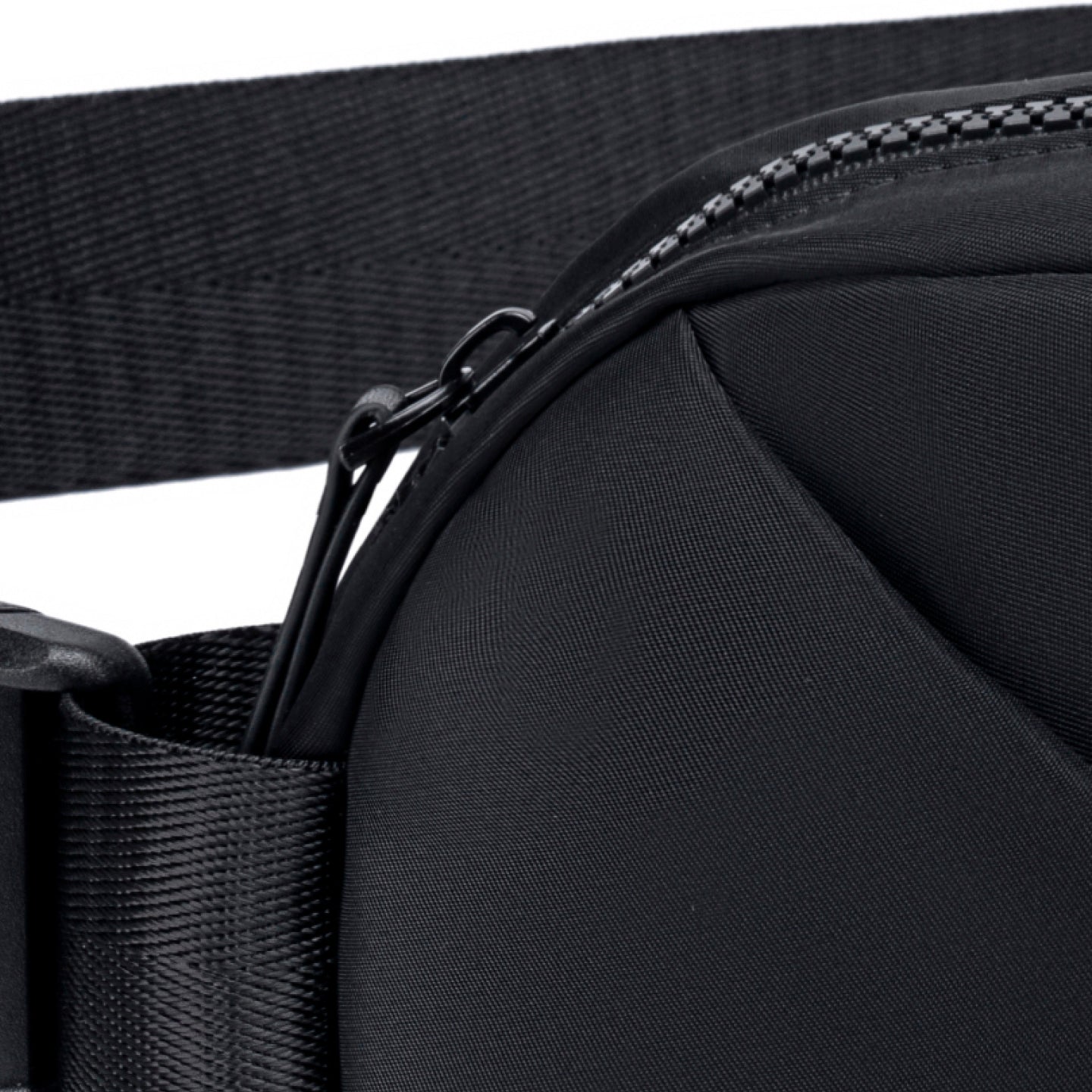 Close-up of a black waist bag with a zipper