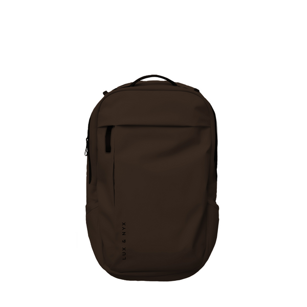 Brown Lux & Nyx Purpose Backpack, front view, with top grab handle, vertical front zip pocket, and side slip pockets