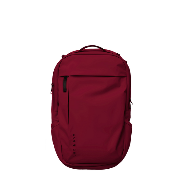 Crimson Lux & Nyx Purpose Backpack, front view, with top grab handle, vertical front zip pocket, and side slip pockets