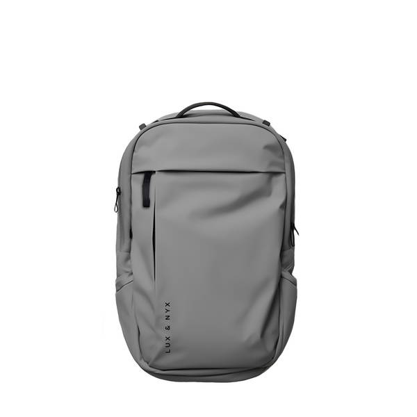 Gray Lux & Nyx Purpose Backpack, front view, with top grab handle, vertical front zip pocket, and side slip pockets