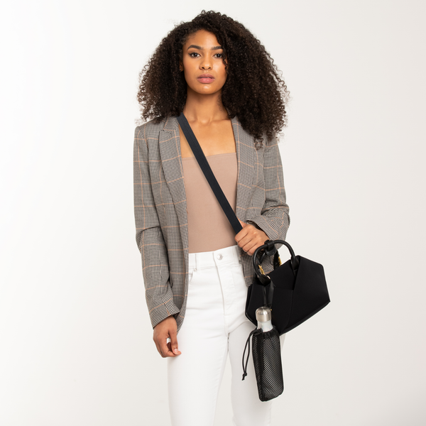 Person wearing a black-with-gold-hardware crossbody handbag with gold-tone hardware &  a small bottle bag attach with it.