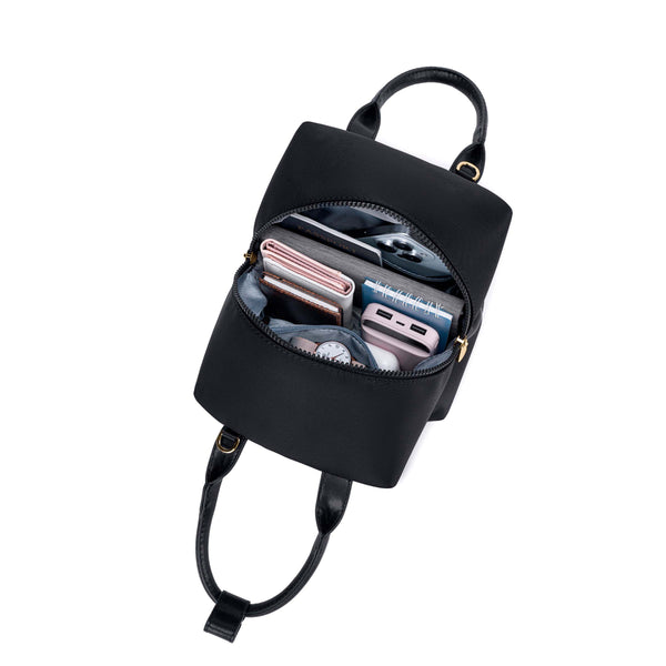 black-with-gold-hardware origami-style leather handbag top view image with inside some materials.