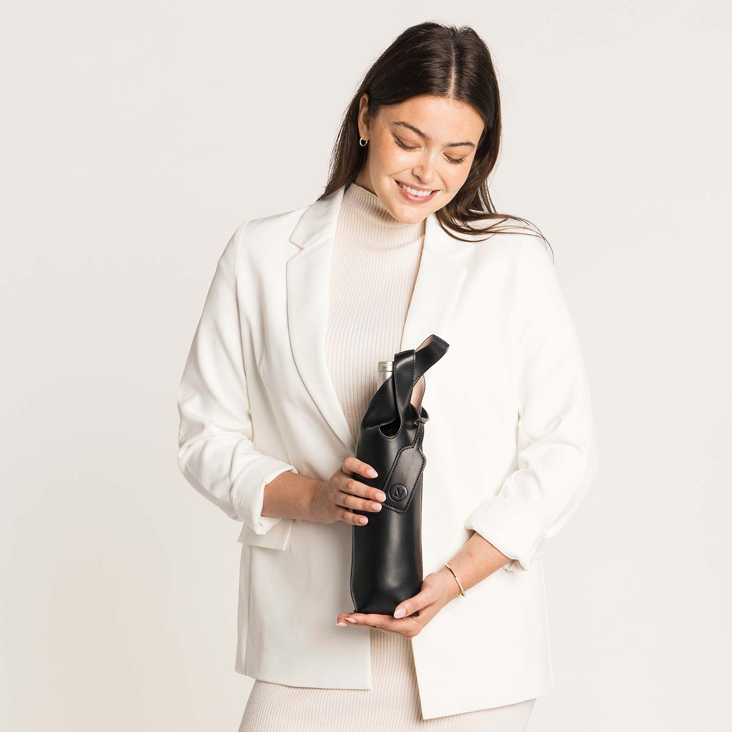 Lux & Nyx Wine Tote - Upcycled Leather - Woman Holding The Wine Tote With A Wine Bottle Inside