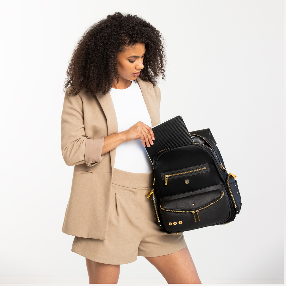 Lux & Nyx Little Zoe Backpack - 13" Laptop Backpack With Detachable 5-Way Wear Crossbody Clutch - Black - A Professional Woman Putting A Laptop Inside The Laptop Compartment