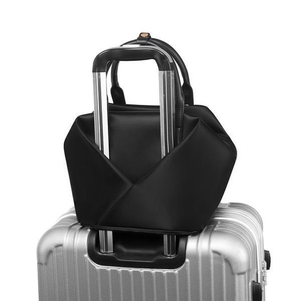 A Black + Gold Hardware handbag over trolly.
